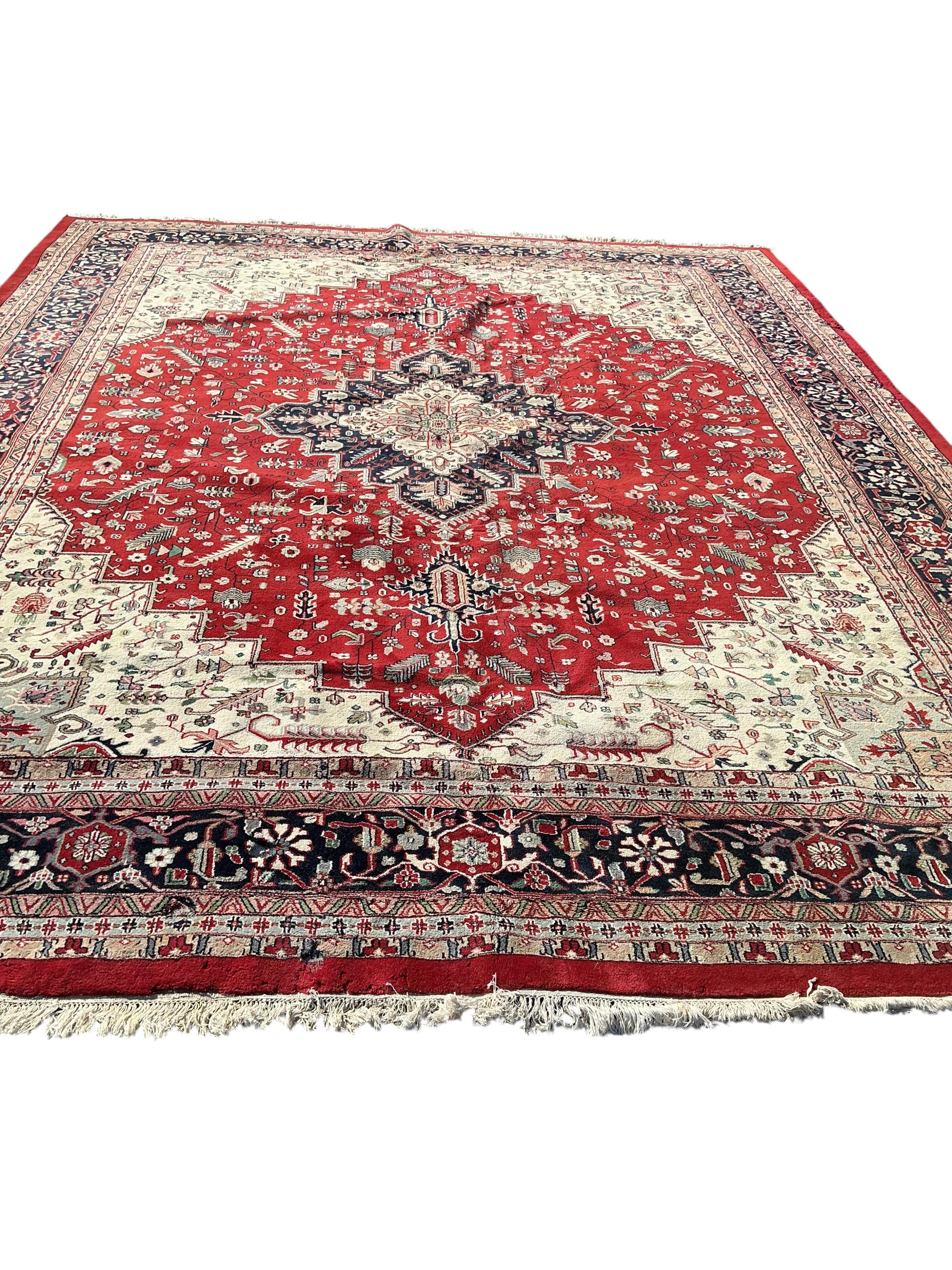 A Heriz red ground carpet, (some old moth damage, now inactive) 455 x 362cm